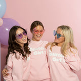 Teenage girls laughing wearing Glitter Girl pink heart sunglasses