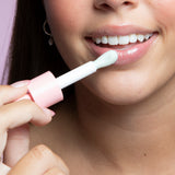 A teenager wearing Sparkle Lip Gloss, featuring a glossy, high-shine finish perfect for any makeup look.