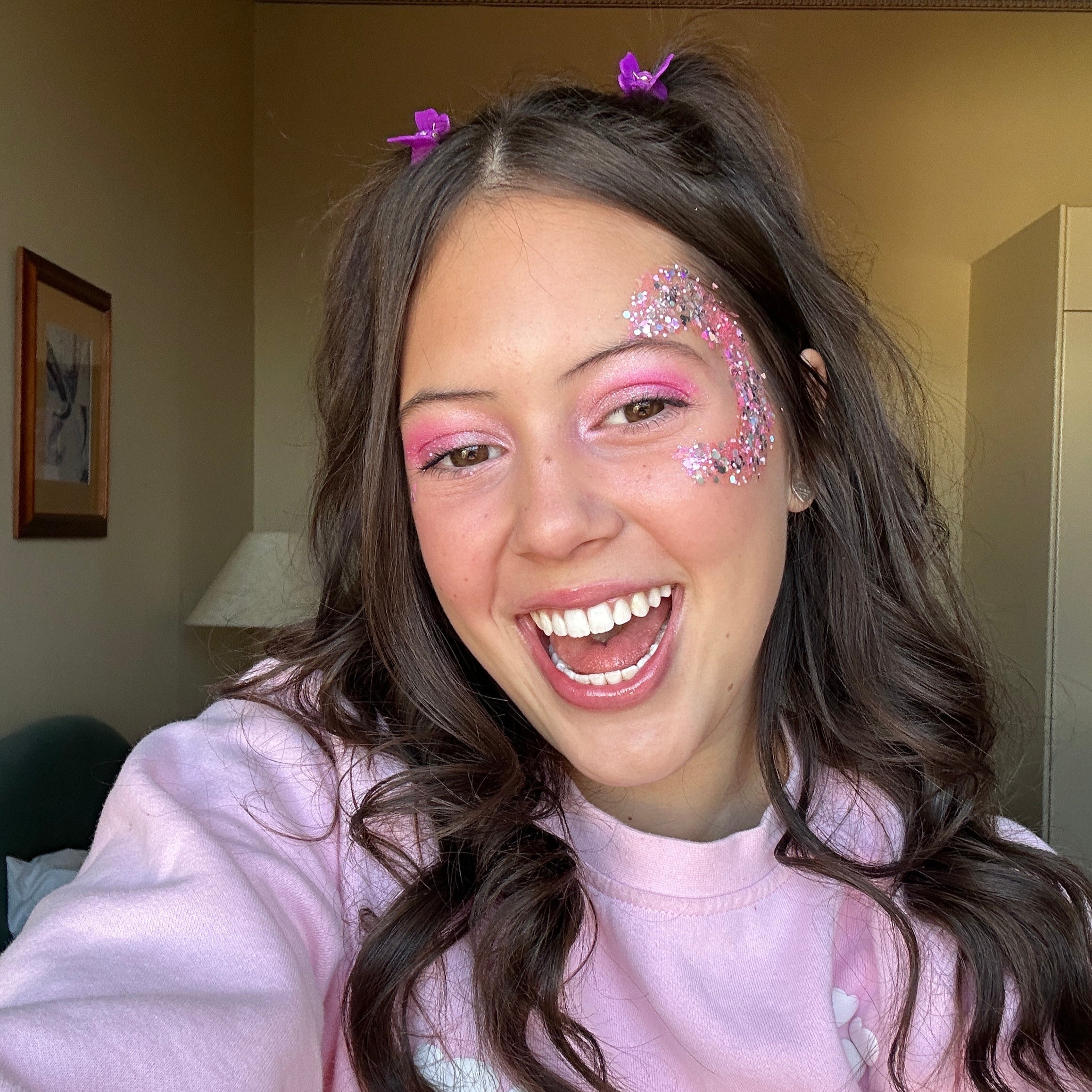 Teenager wearing Shimmering pink eyeshadow palette and lip gloss – perfect for creating a festival-ready, radiant makeup look.
